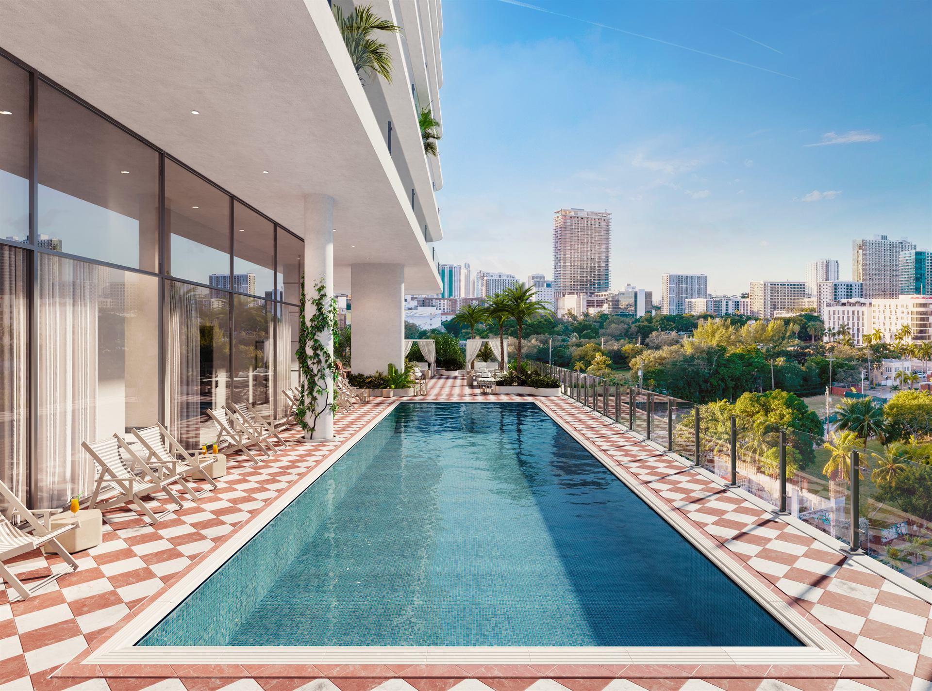 Resort pool and lounge seating at ELLE Residences